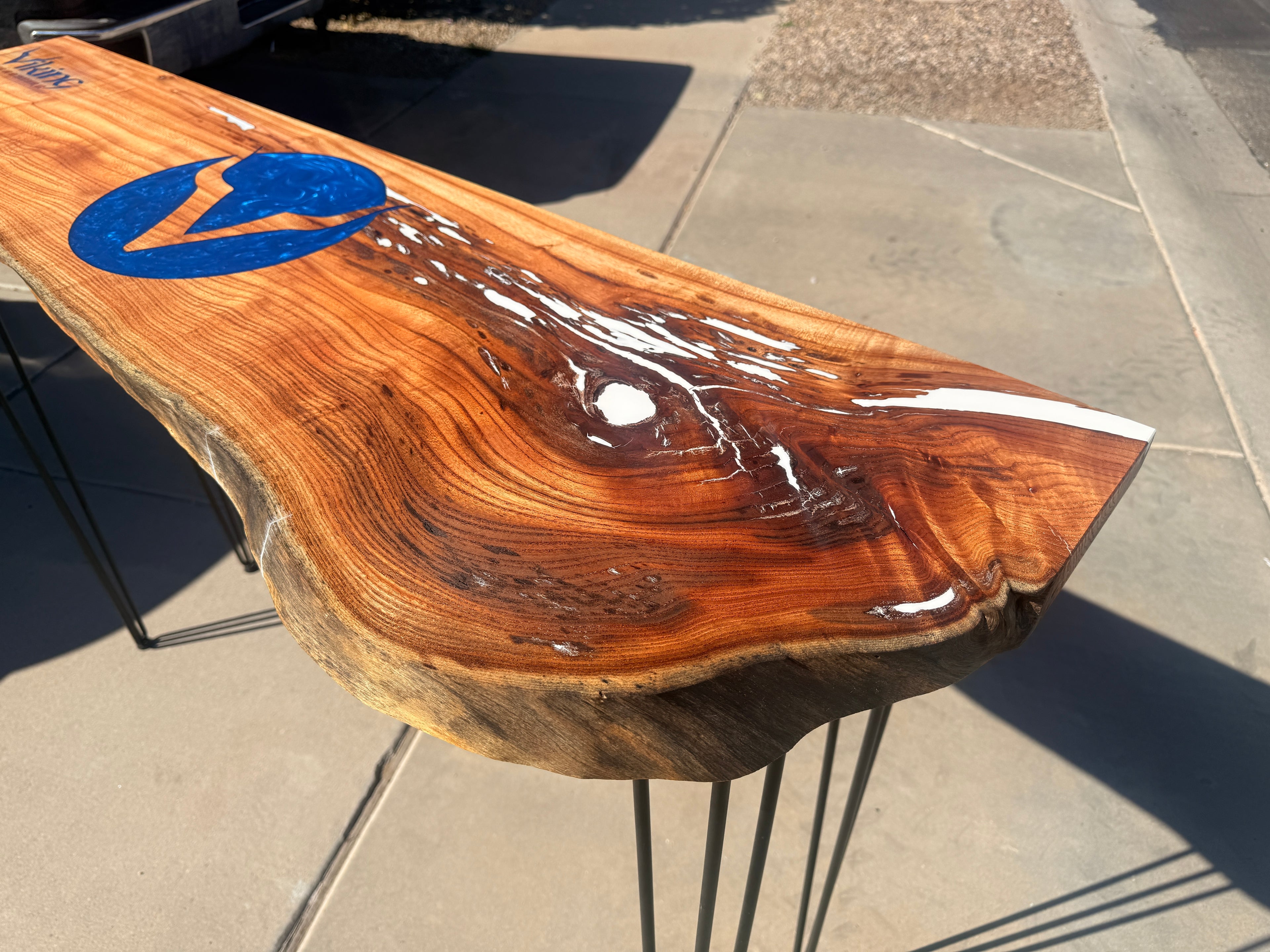 Wooden table with a blue logo