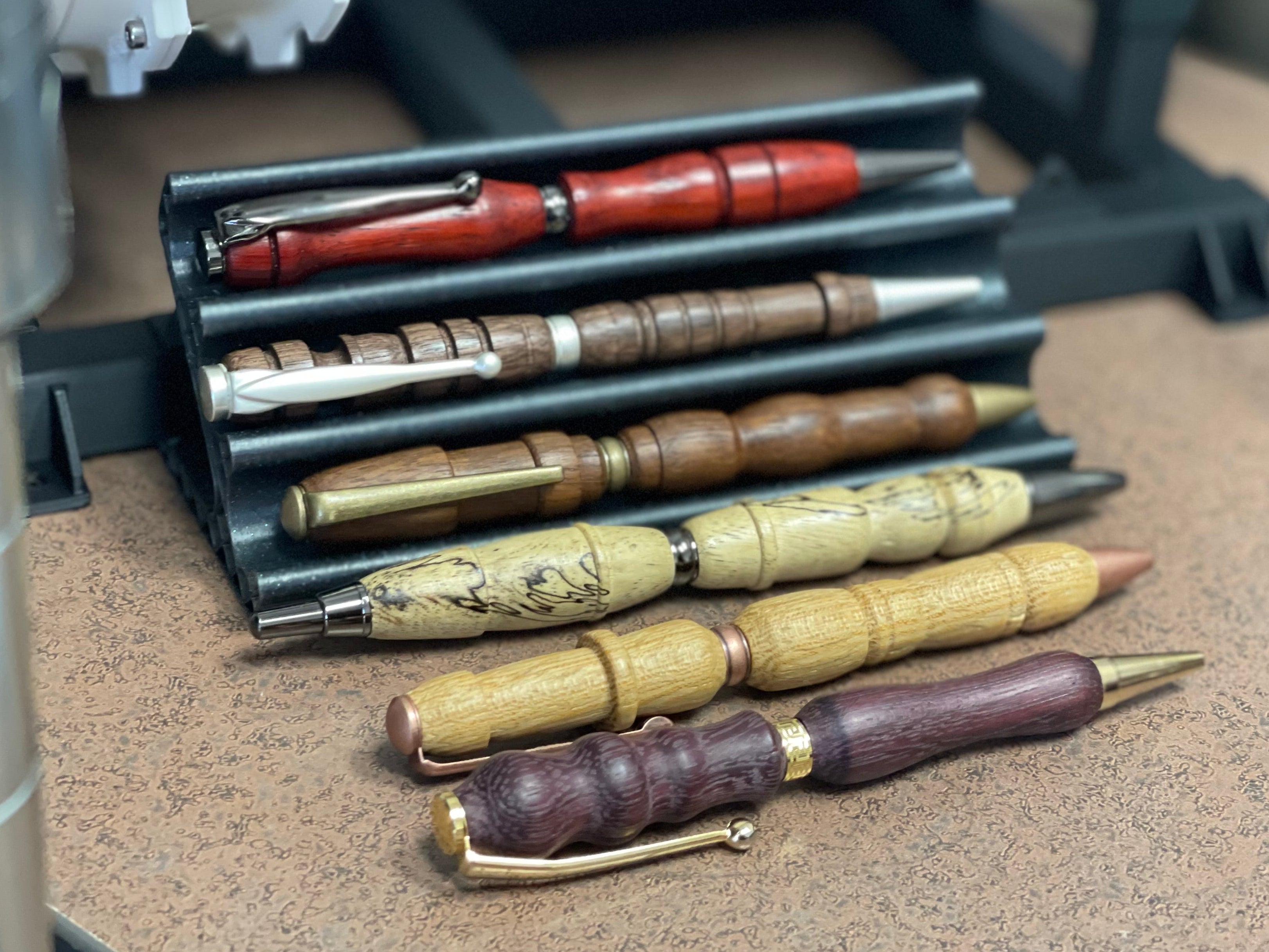 Collection of wooden pens with metal accents on display